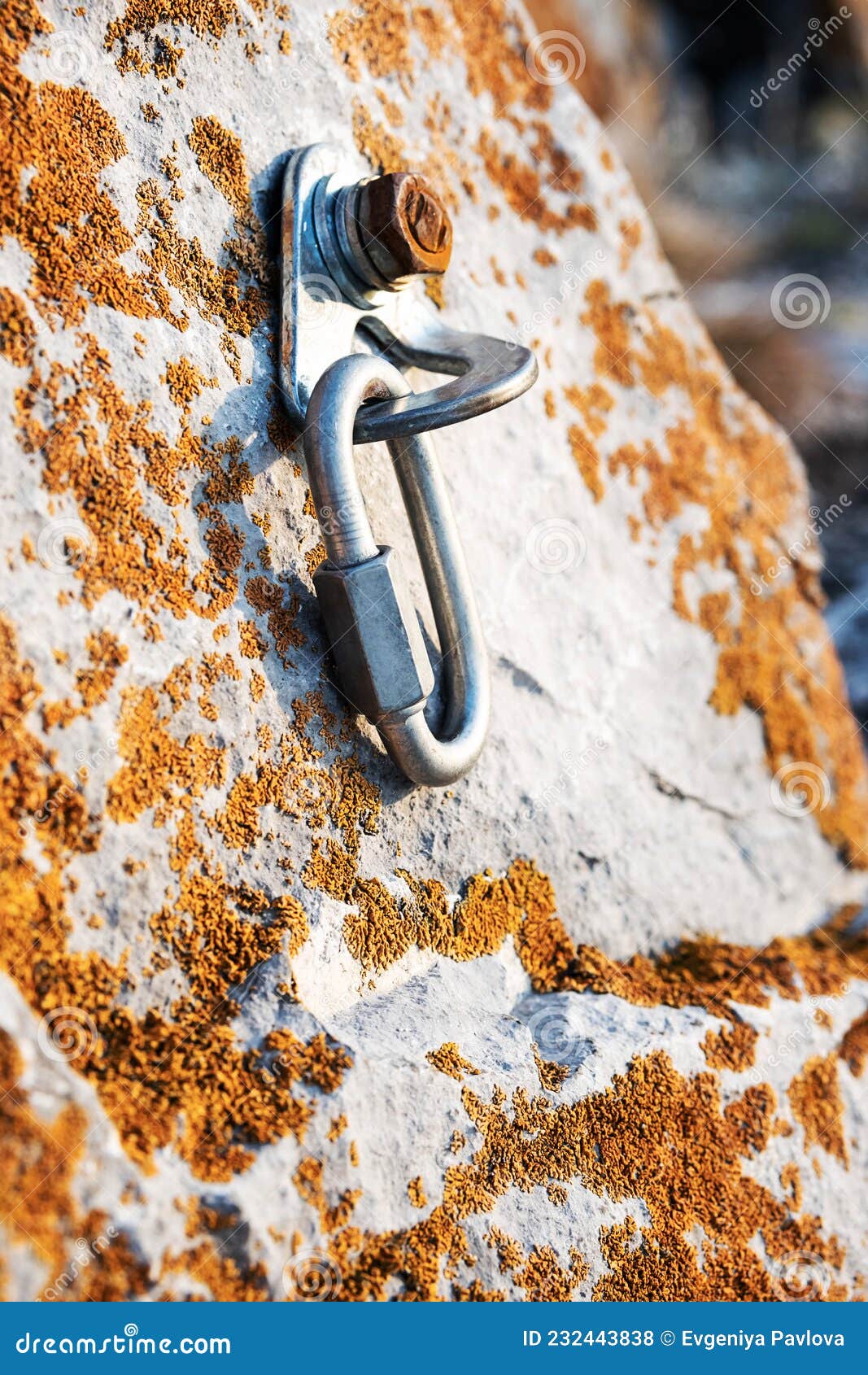 ÃÂ¡limbing carabiner hook and trigger device in stone. carabiner for mountaineering on rocky background.